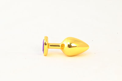 Золотистая анальная пробка с фиолетовым камушком в виде сердечка  S RY-019