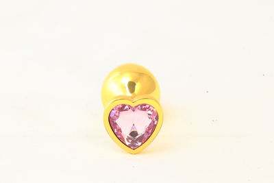 Золотистая анальная пробка с розовым камушком в виде сердечка  M RY-020